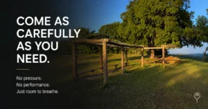 Outdoor church garden with wooden pergolas and a large shade tree beneath the words, "Come as carefully as you need. No pressure. No performance. Just room to breathe."